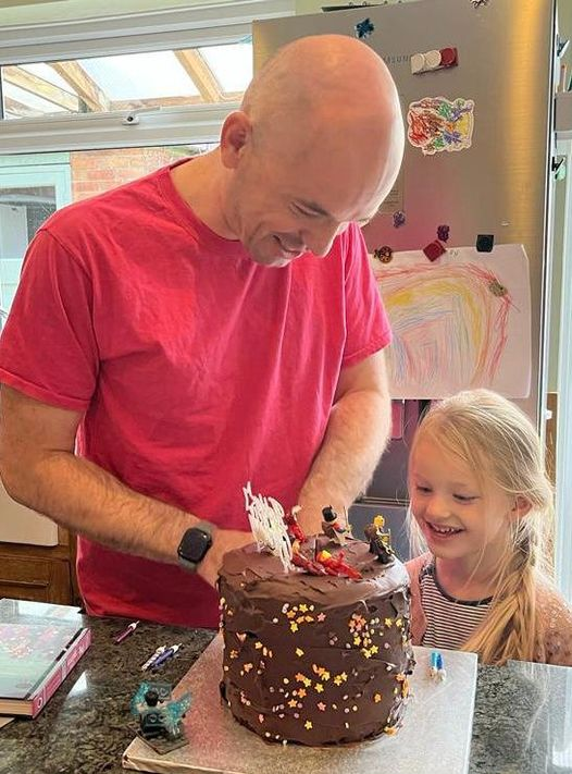 Nova helping Joe Reddington cut cake