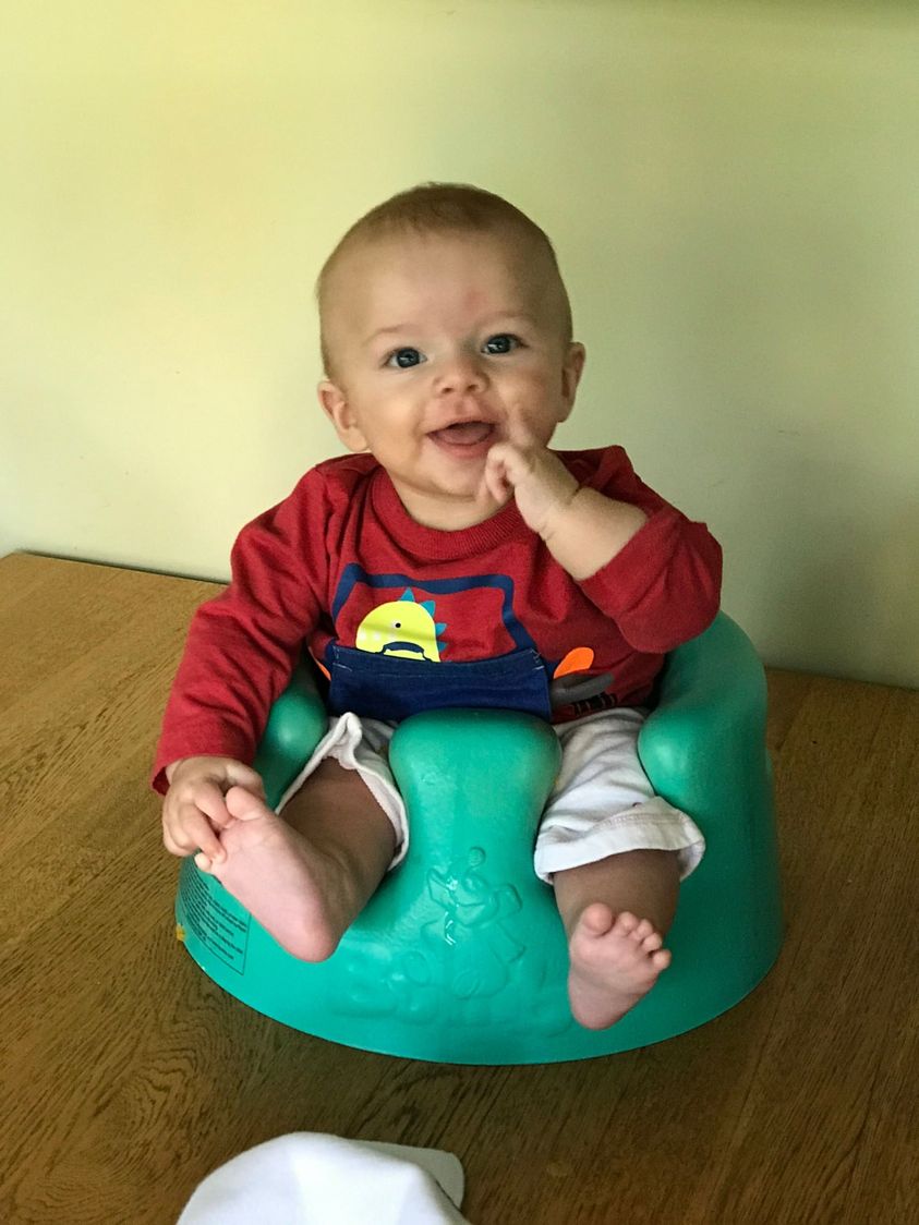Leo in a bumbo chair on the table