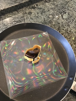 Some chocolate on a diffraction grid, the grid is reflecting rainbows